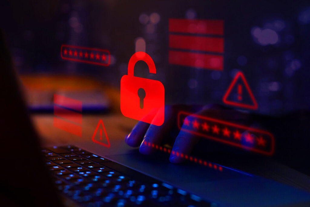 Red unlocked padlock icon symbolizing data breach on laptop